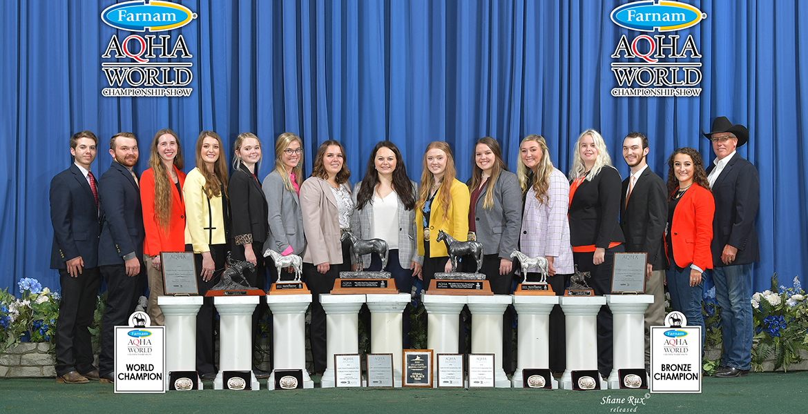 Team photo at championship with trophies.