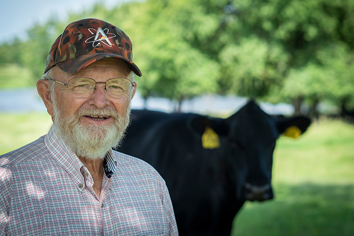 Photo of Bob Wettemann in a cattle pasture.