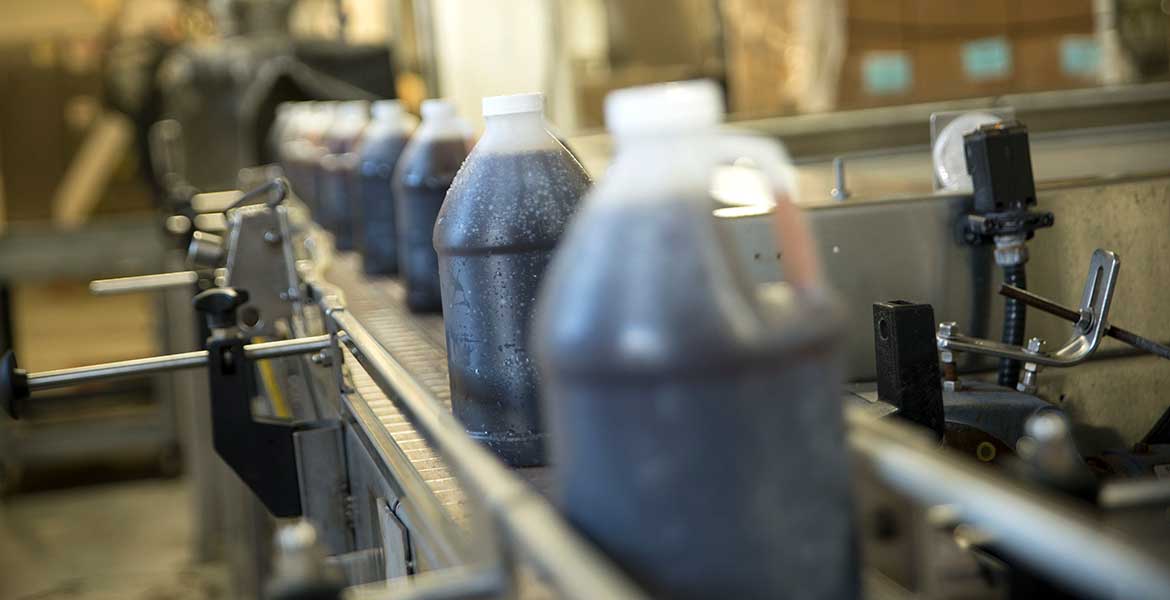 bottles of syrup on a food manufacturing line
