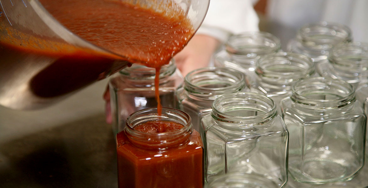 pouring sauce in jars