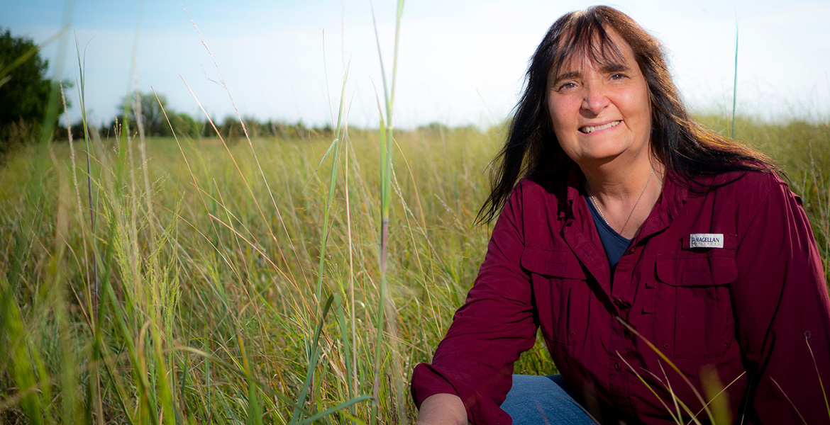 Photo of Gail Wilson in a pasture.