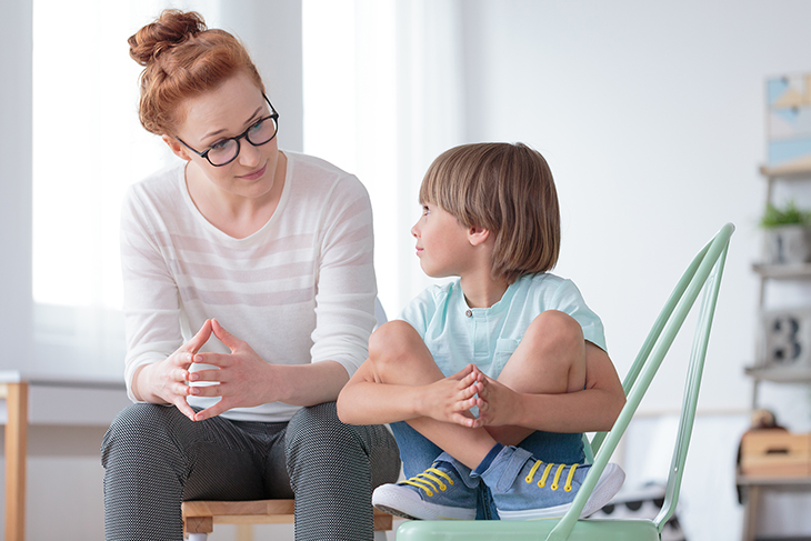 Photo of adult talking with child.