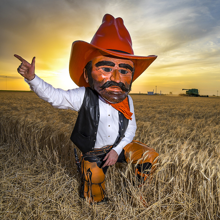 Kevin Osborn poses as Pistol Pete in his family's wheat fields.