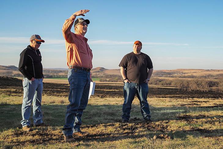 Photo of Leland McDanield giving a presentation on-site in a pasture that has been patch burned.