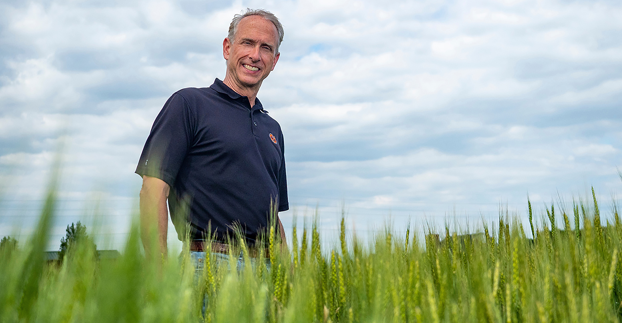 Photo of Brett Carver in a wheat field.
