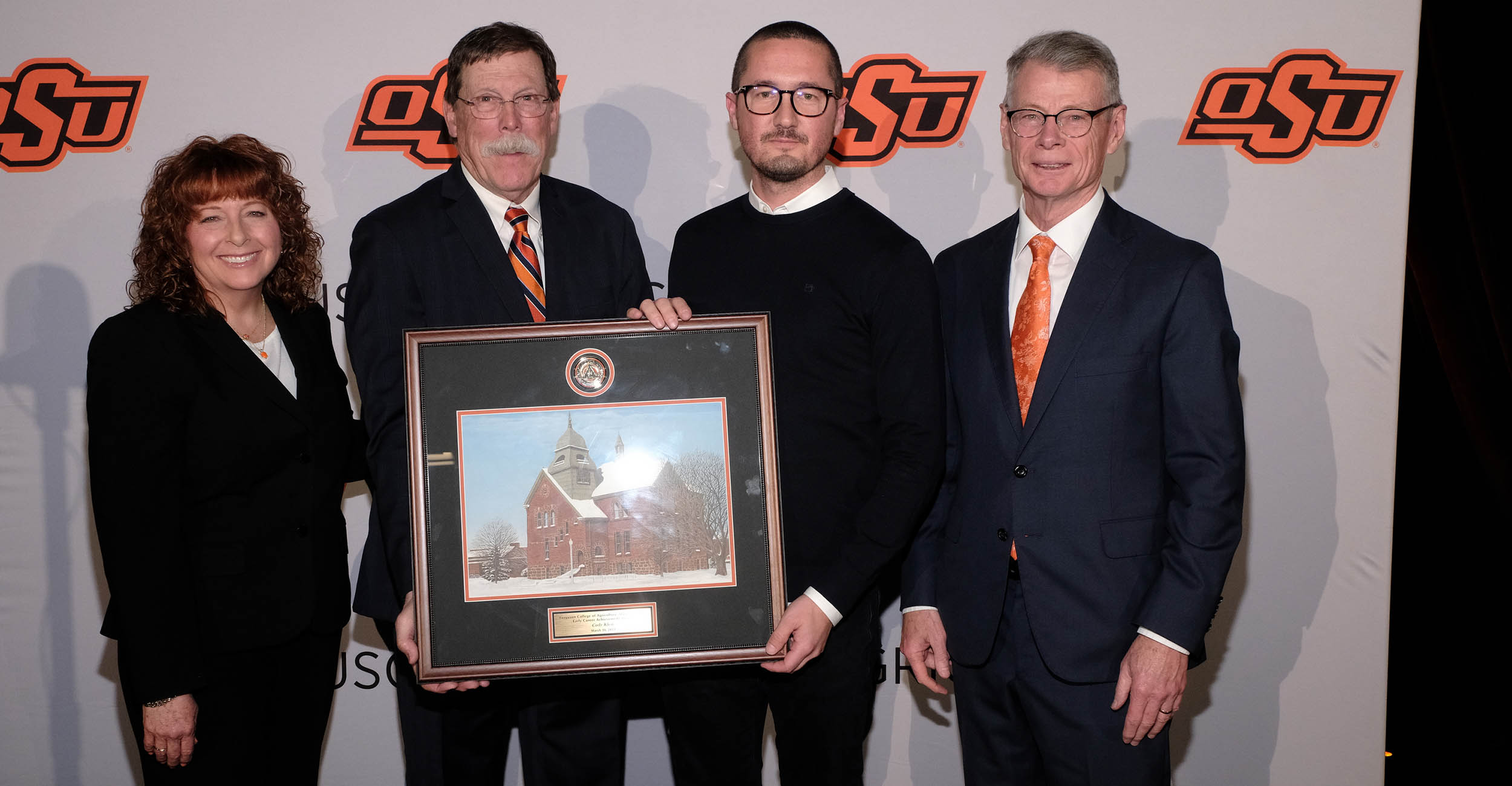 From left, Cynda Clary, Rick Reimer, Cody Klein and Thomas G. Coon standing in front of an OSU Agriculture backdrop