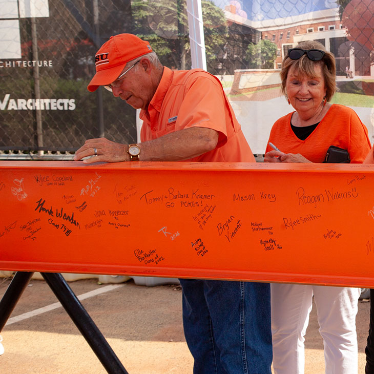 Keith and Marlene Kisling sign New Frontiers beam