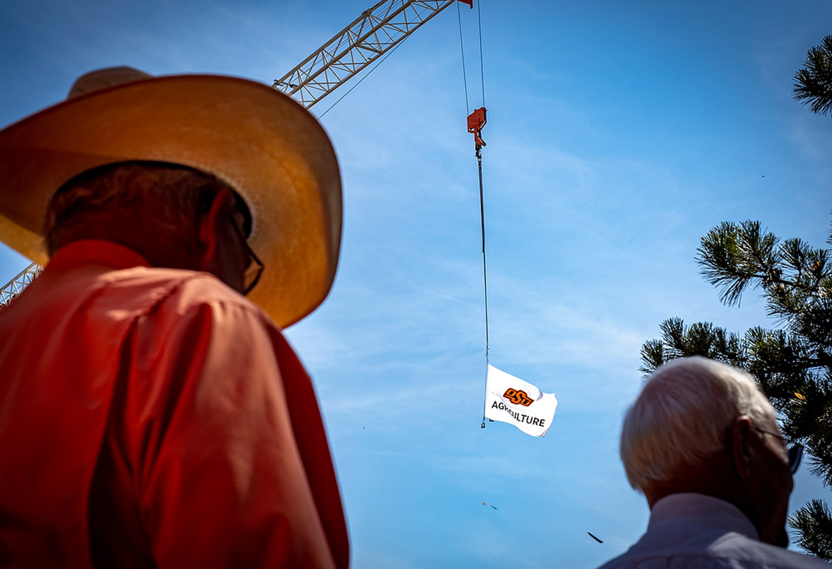 New Frontiers flag flying from crane