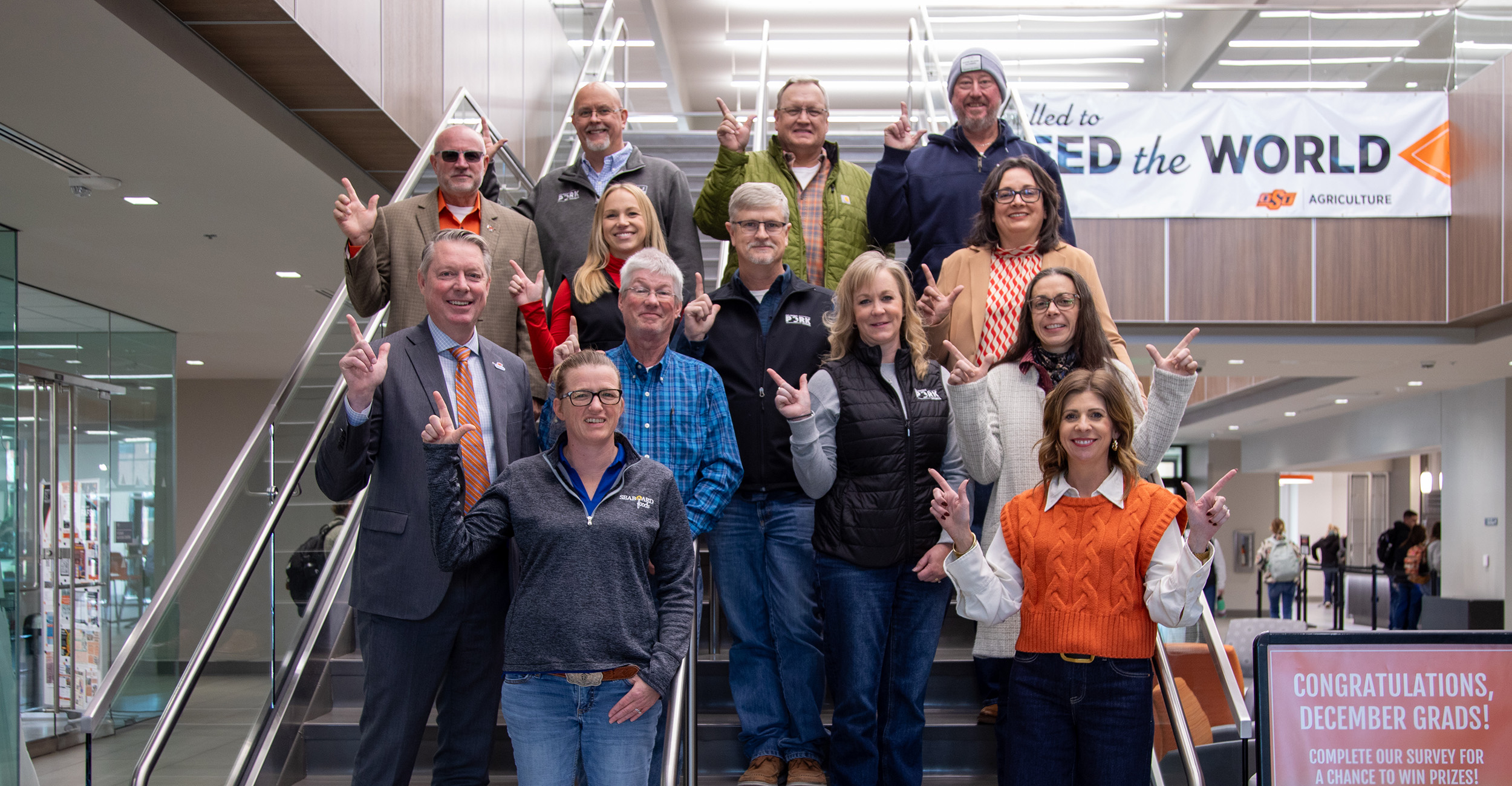 Board members of the Oklahoma Pork Council stand on the stairs of Agricultural Hall.