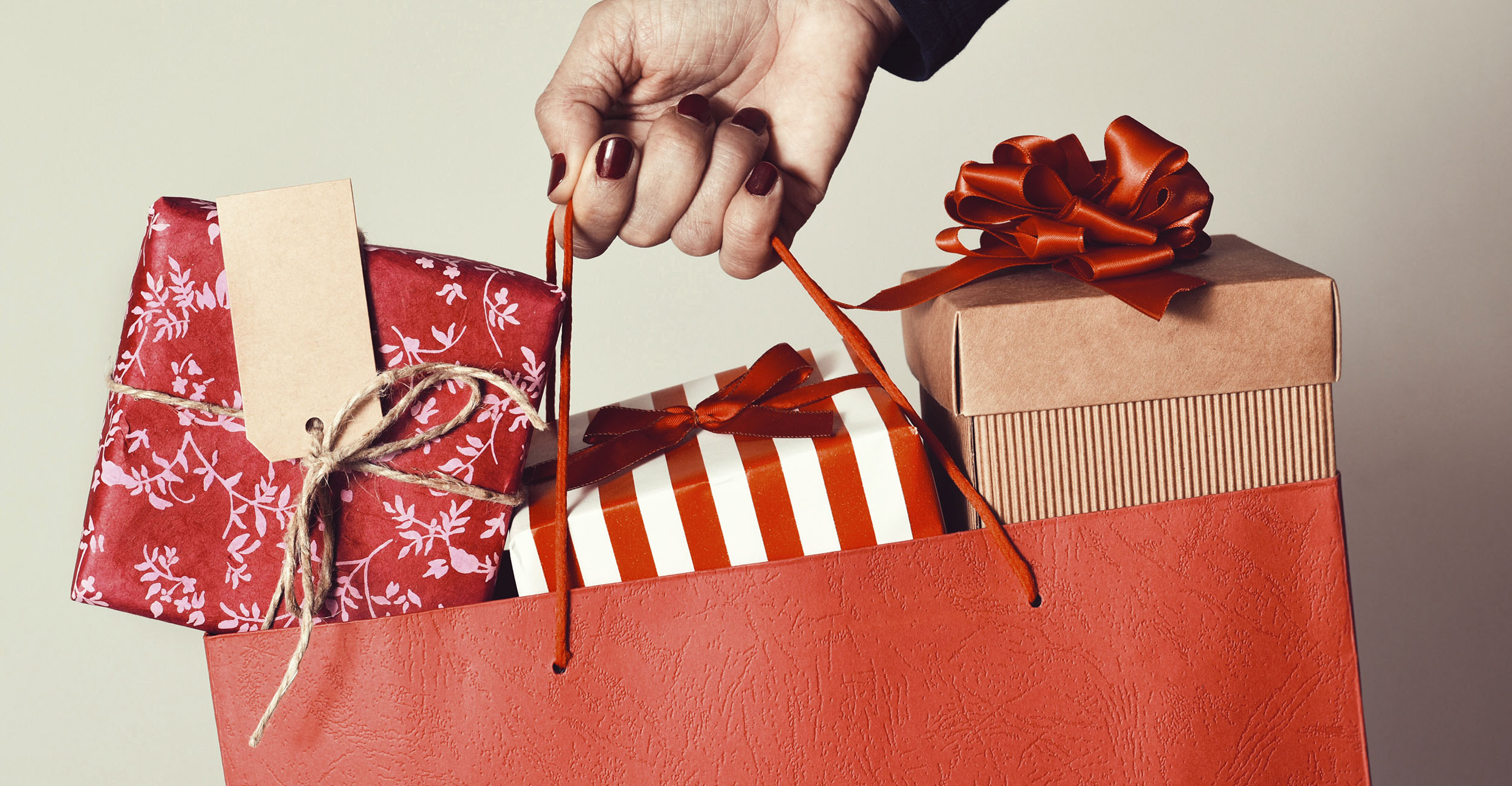 Shopping bag with wrapped gifts.