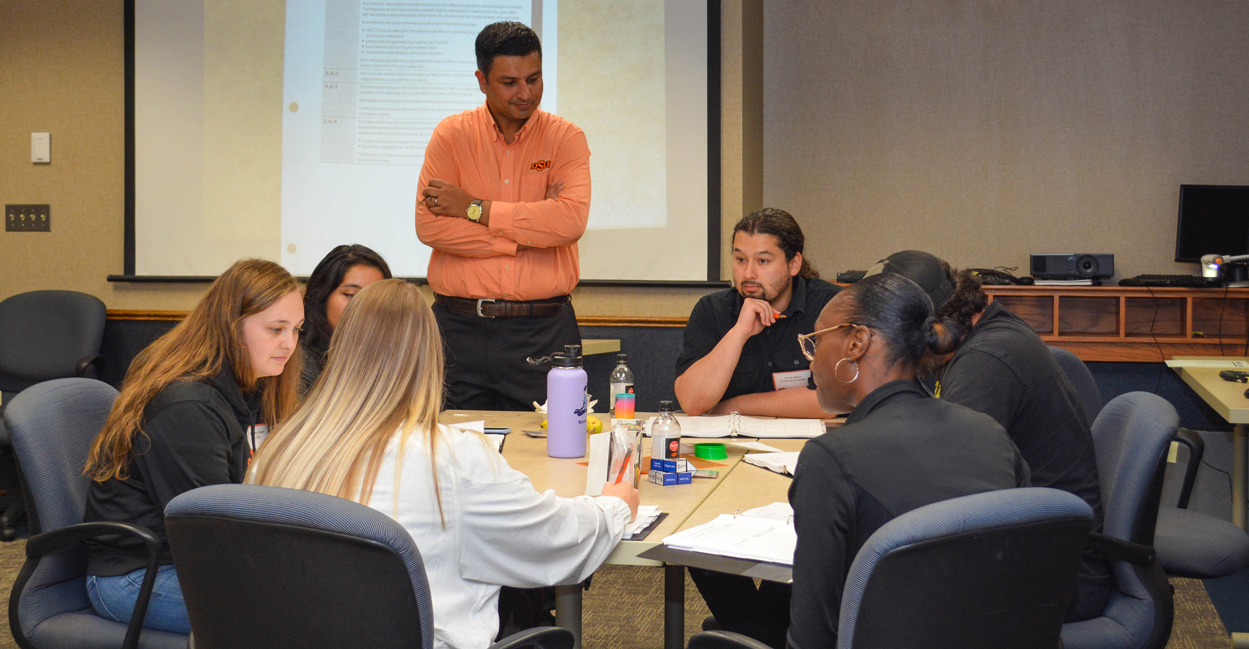 People sitting at a table during a training workshop.