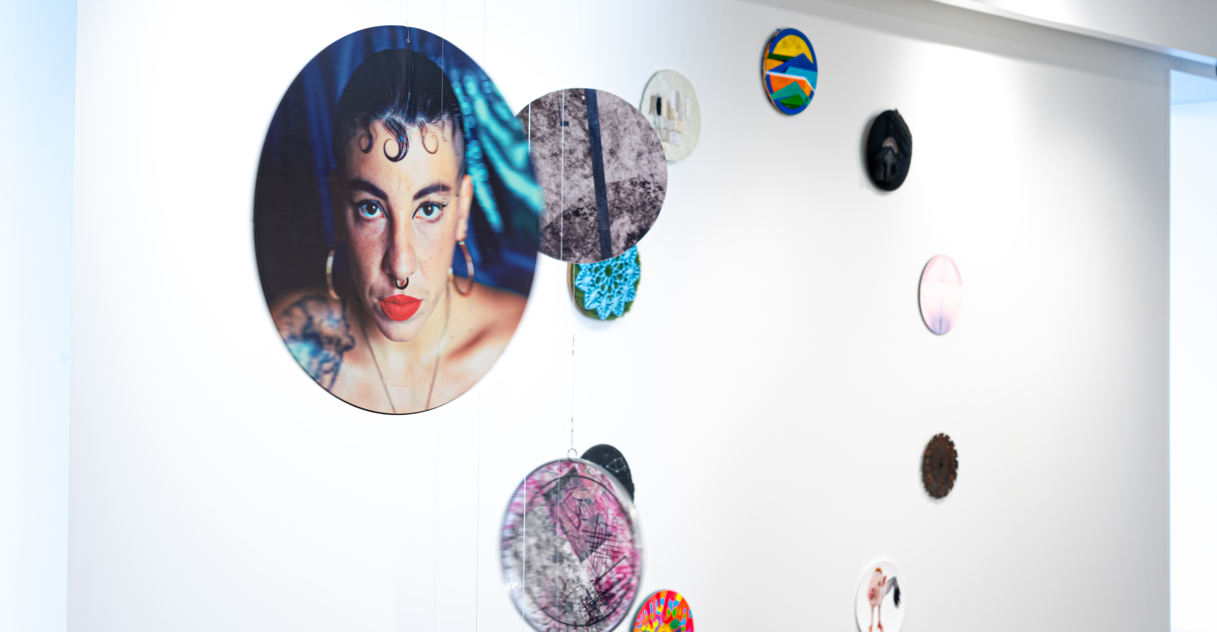 Traveling art exhibition "24 Hours of Wonder" features 49 artworks in 12-inch circular formats.