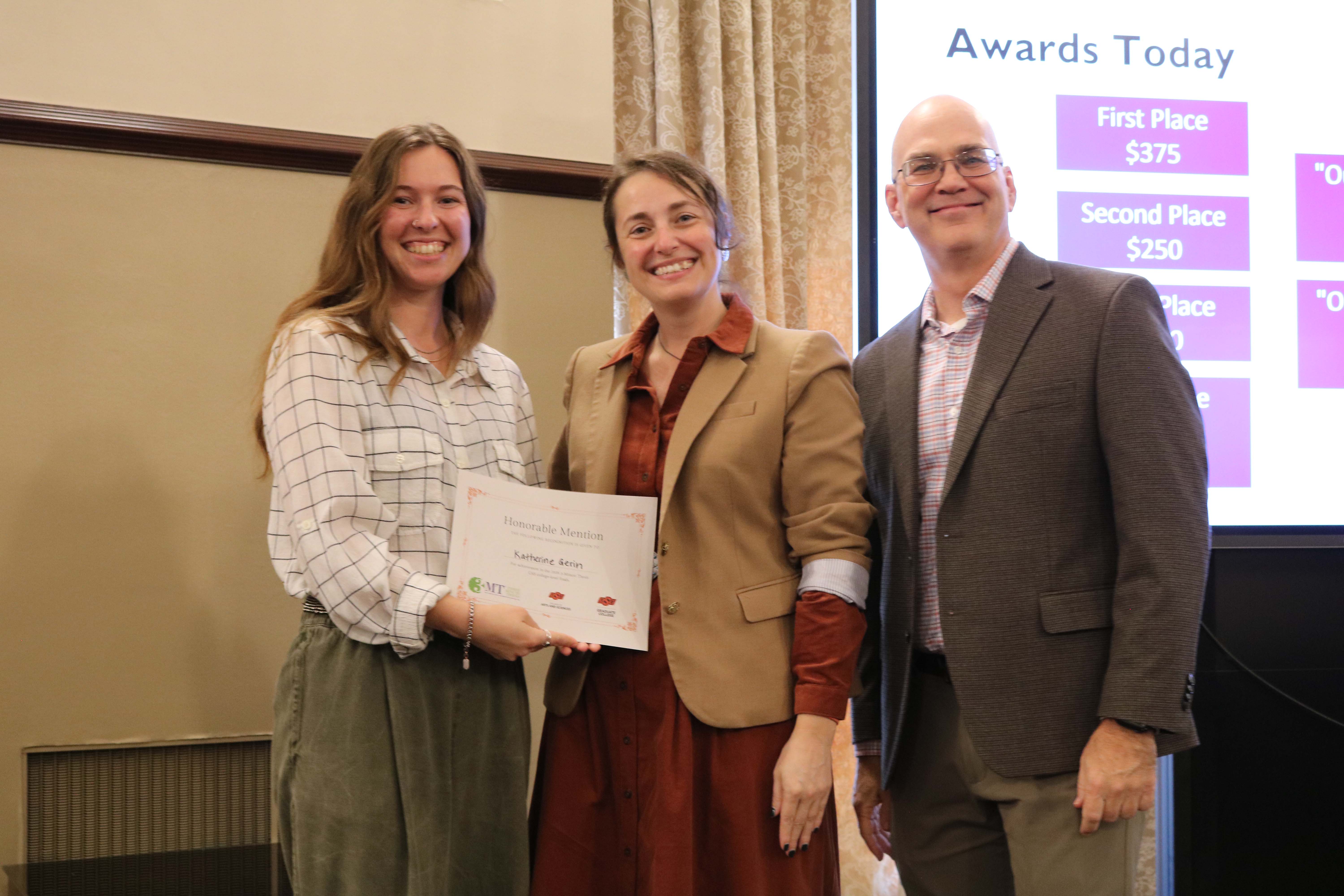 Honorable mention in the 2026 College of Arts and Sciences Three Minute Thesis competition, Kathrine Gurin, with Dean Melinda Cro and Associate Dean for Research Jason Belden.