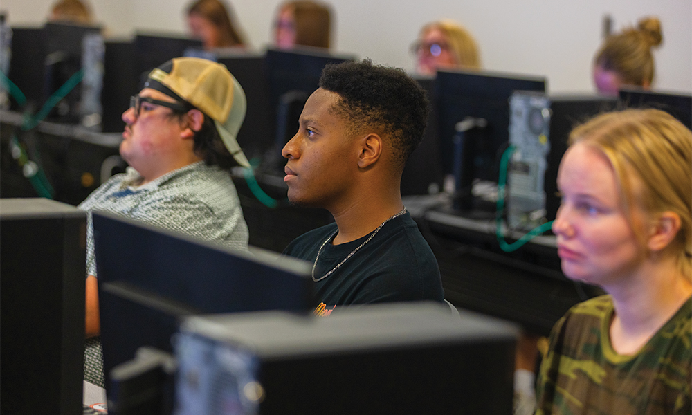 HTM students watching a lecture from Steven West in front of their computers