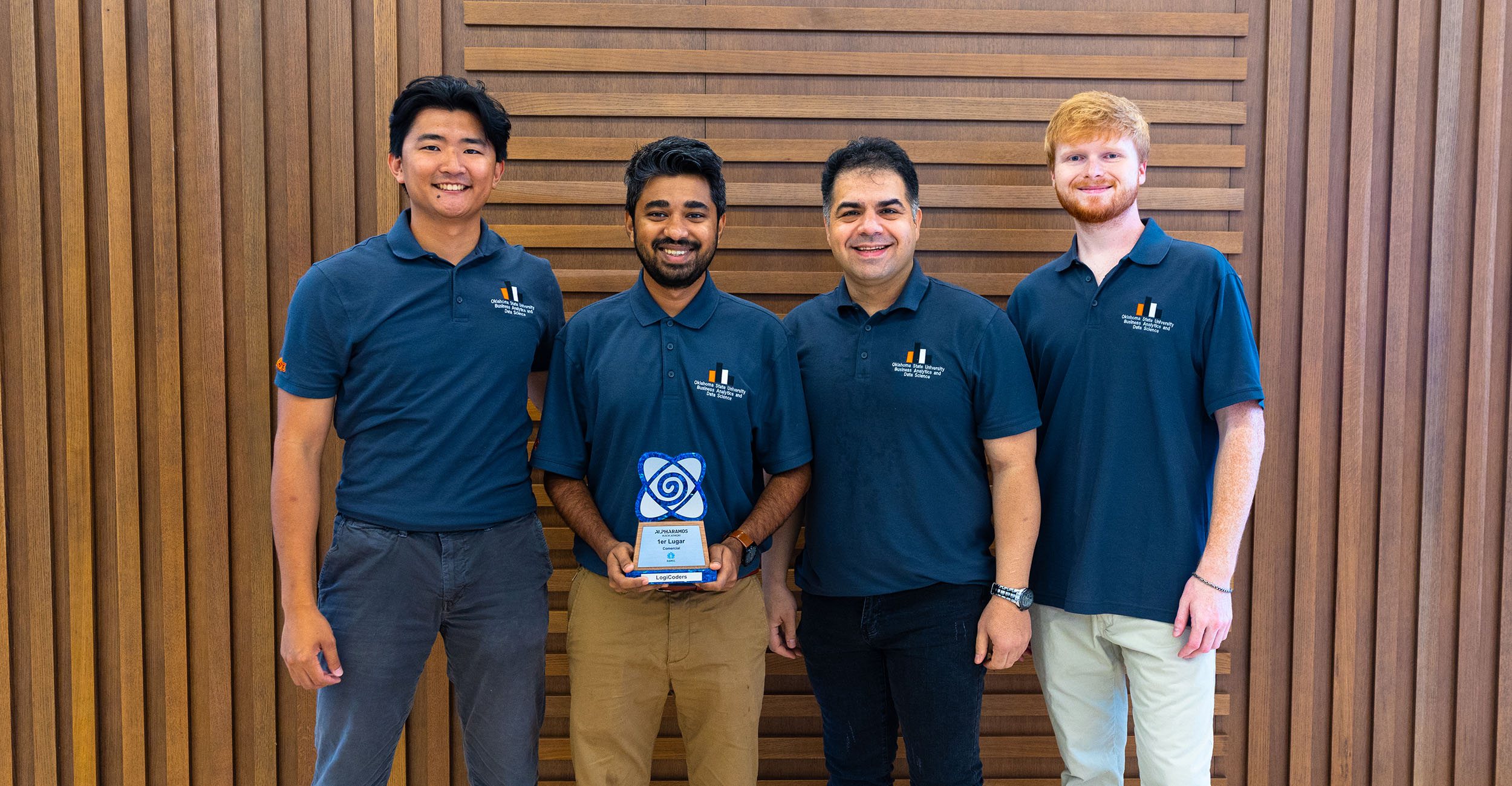 The four students pose with their trophy.