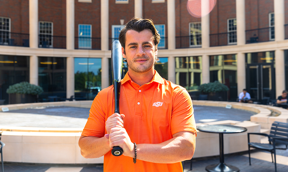 Steve Azzaro poses with his baseball bat.