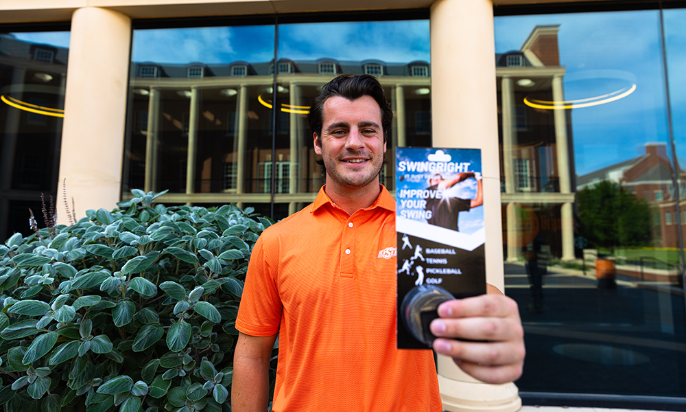 Steve Azzaro holds the packaging for his product, the SwingRight.