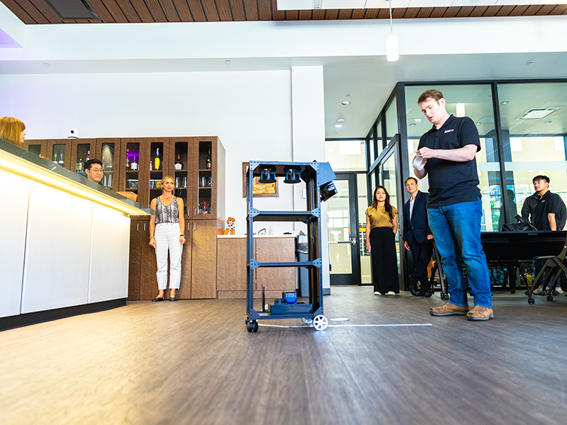 The robot rolls across the floor.
