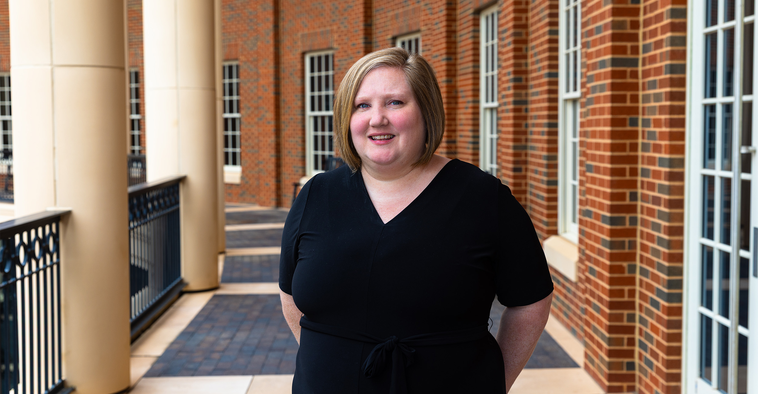 Caitlin Kelley, director of the OSU Center for Advanced Global Leadership and Engagement, poses on the balcony of the Business Building.