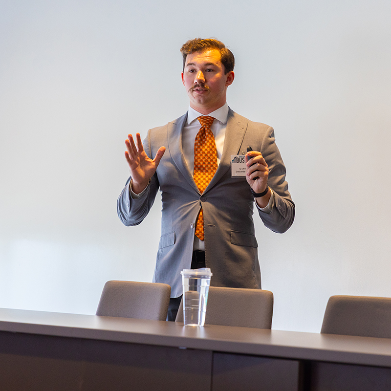 Charles presents A student talks while explaining a business plan.