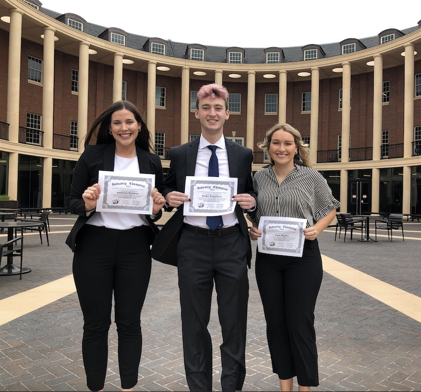 students in front of business building