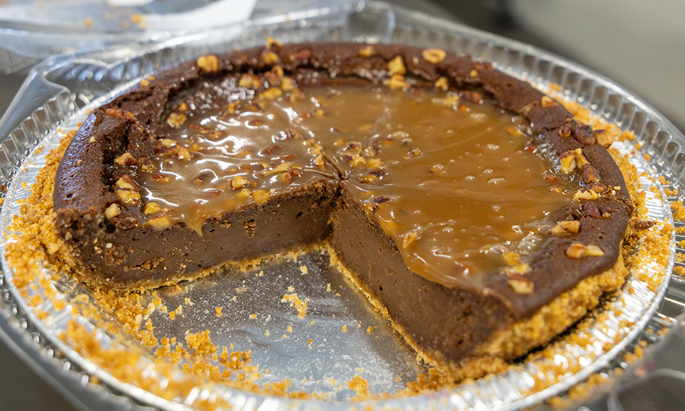 a rich chocolate pie with a turtle glaze and a couple of slices cut out