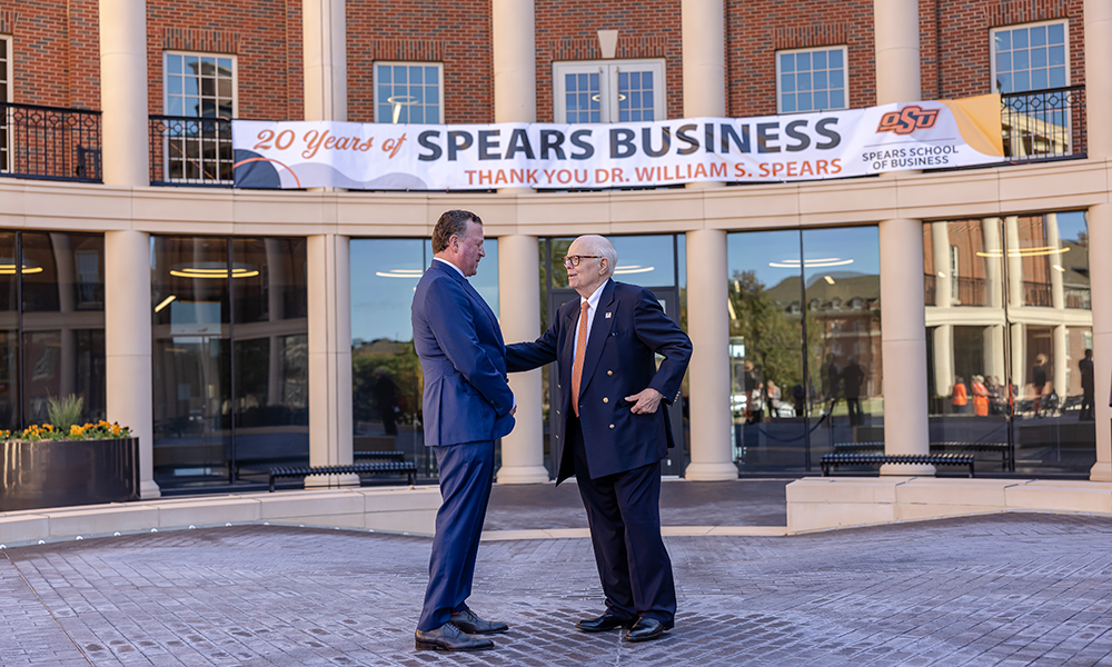 OSU alumni Joe Eastin and Dr. William S. Spears meet outside the Business Building.