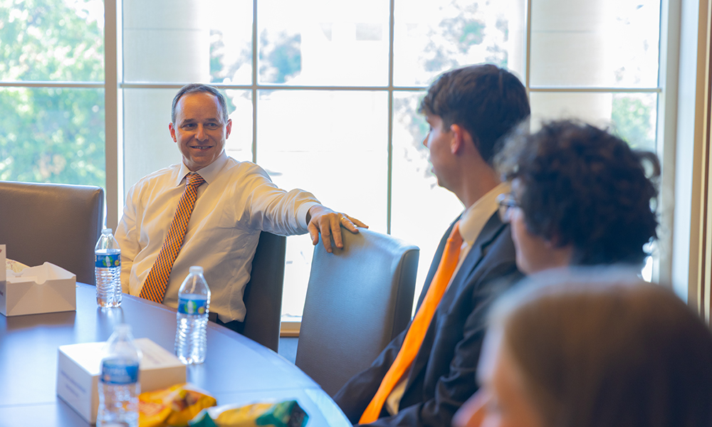 Bryan Edwards listens to students talk in the conference room.