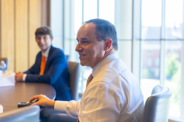 Bryan Edwards smiles while meeting with students in a conference room.