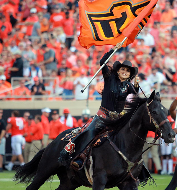 Elise Wade leads Bullet onto the field at Boone Pickens Stadium.