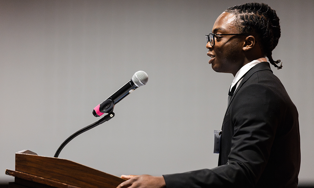 Femi Abioye speaks into a microphone