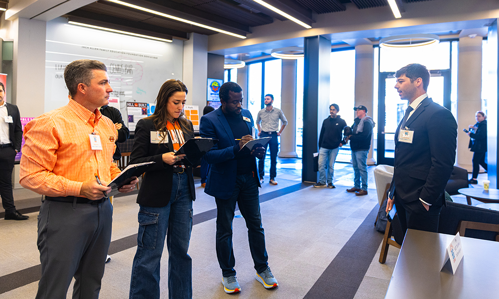 Judges take notes Judges take notes during a student's pitch.