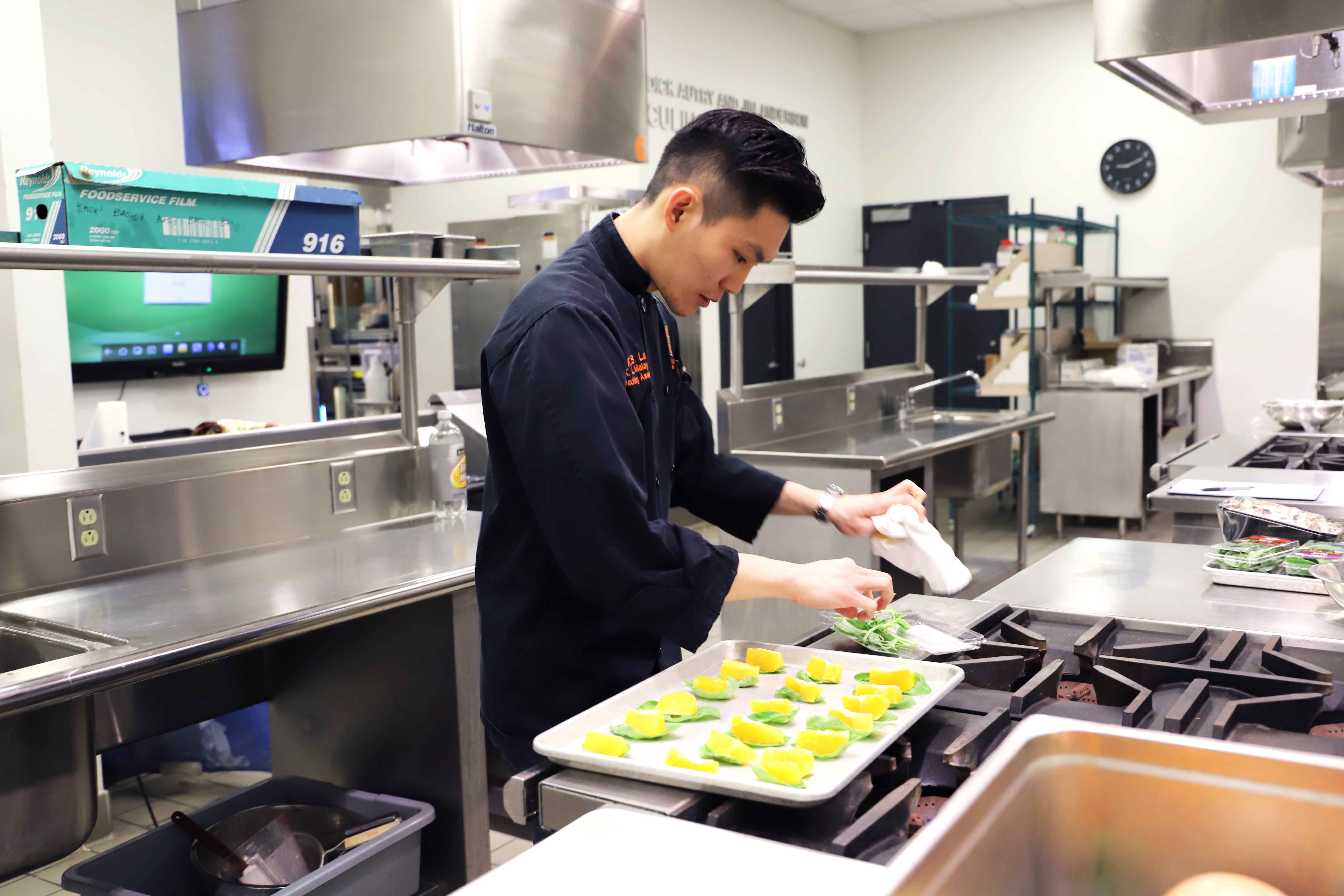 Kai Sean Lee preparing dishes for his students to taste and analyze