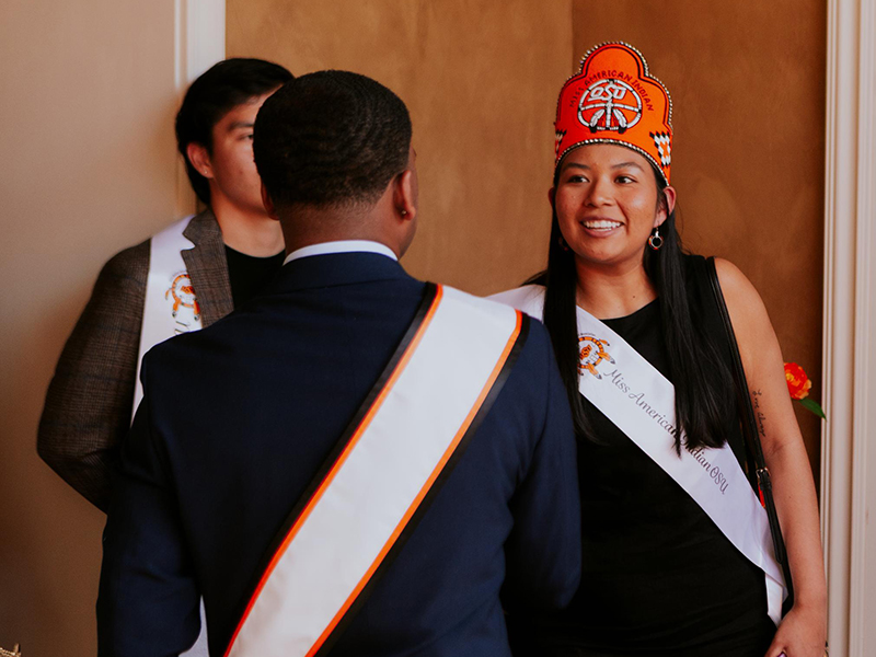 Miss American Indian OSU Cydnee Miller shakes hands with Mr. OSU Anthony McNeal.