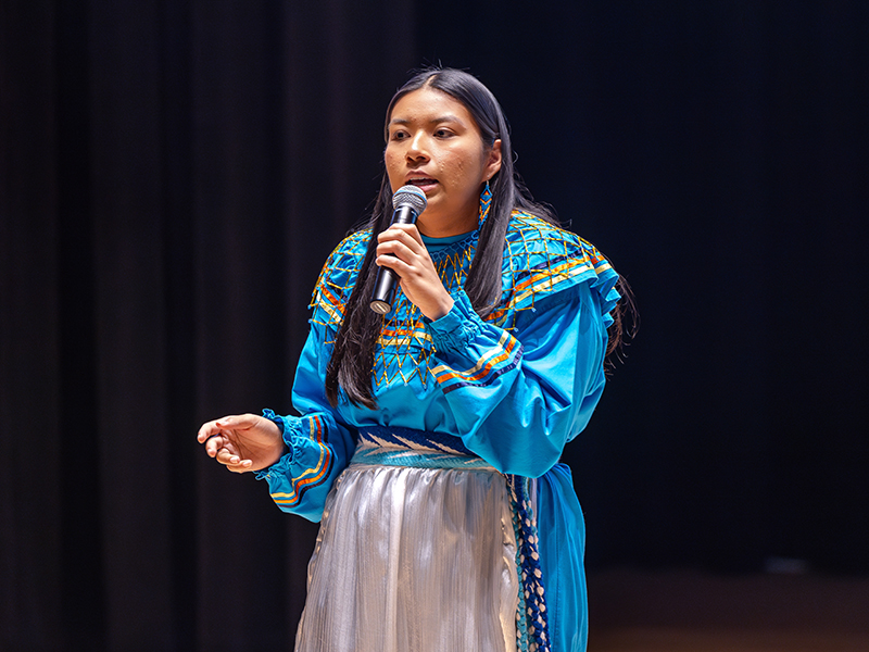 Cydnee Miller speaks on stage at the Mr. and Miss American Indian OSU pageant.