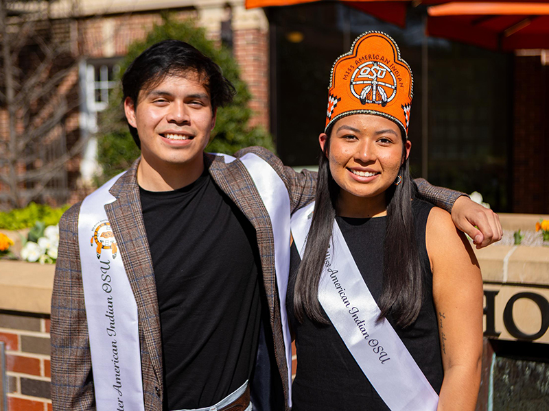Jaden Waters and Cydnee Miller, Mr. and Miss American Indian OSU, pose for an outdoor photo.