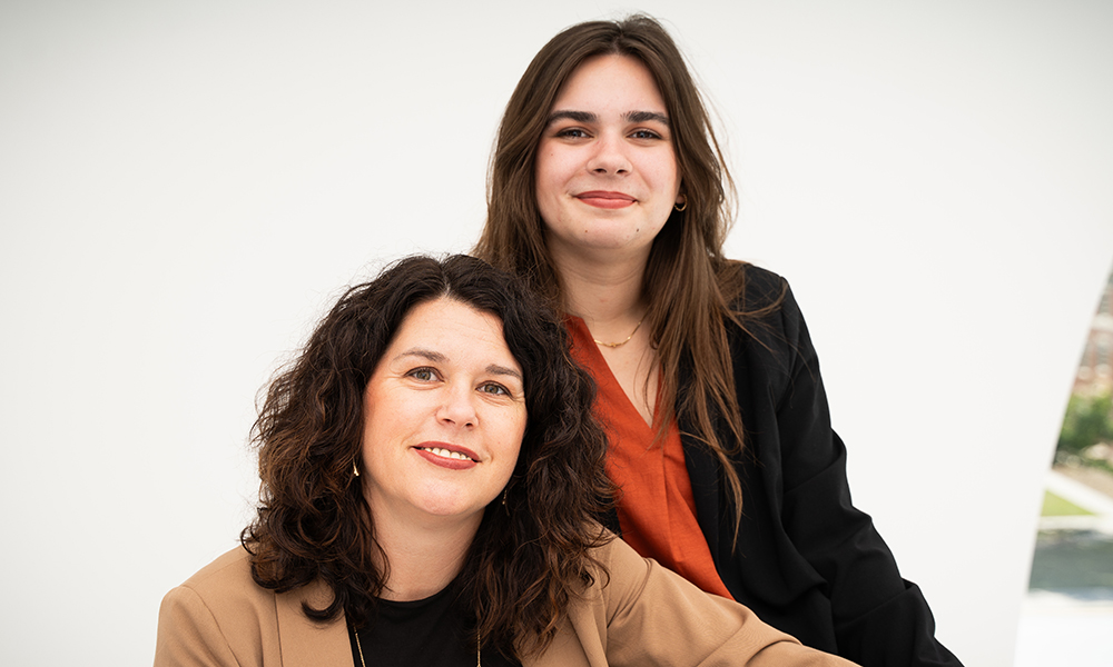 Mother and daughter sit side by side