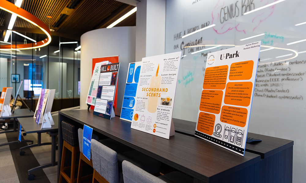 Posters lineup Posters are displayed on tables at the Student Innovation Expo.