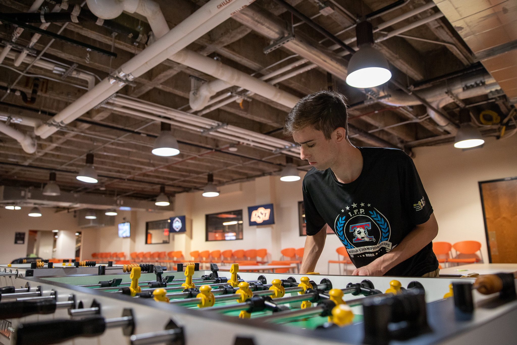 Reid Rector playing foosball at the Cowboy underground. 