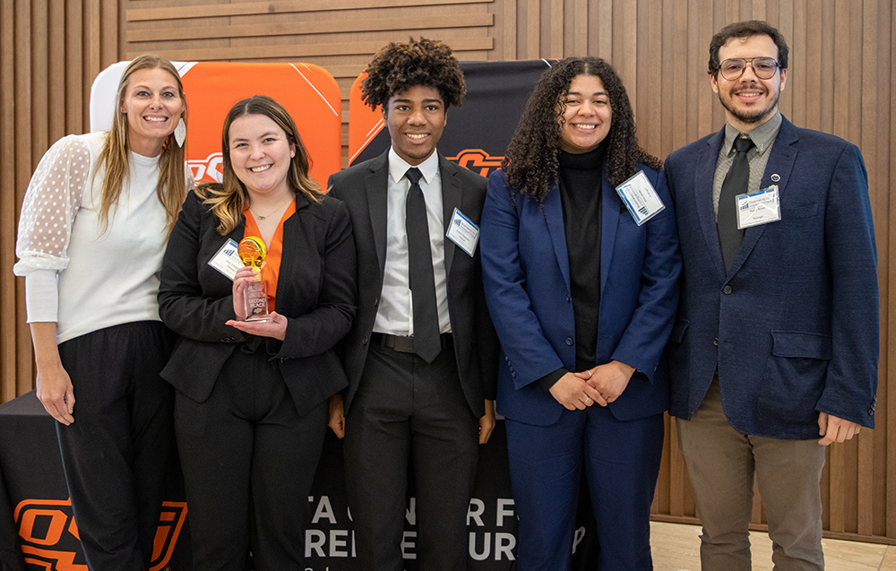 Paula McCullough congratulates the ParkingU team of Amy Campbell, Aaron Chambers, Alexis Drake and Rosty Bruce.