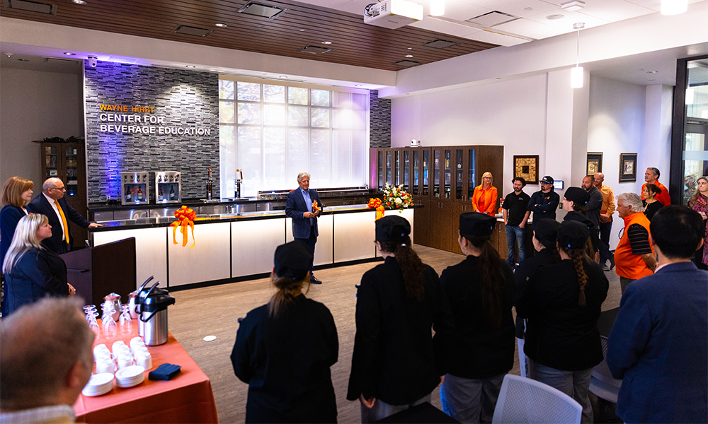 Mike Rogers speaks in front of a group of students, faculty and staff at the new bar dedication at the Wayne Hirst Center for Beverage Education.