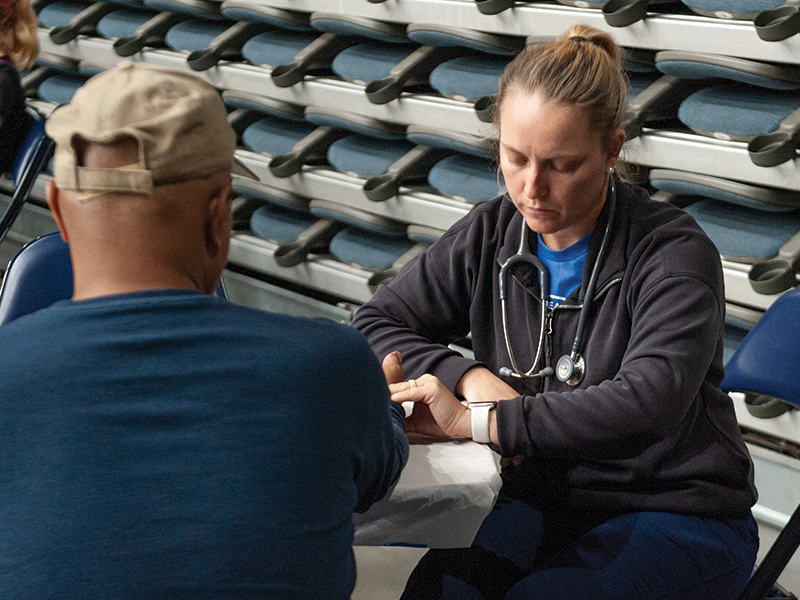 A health care provider checks a patient.