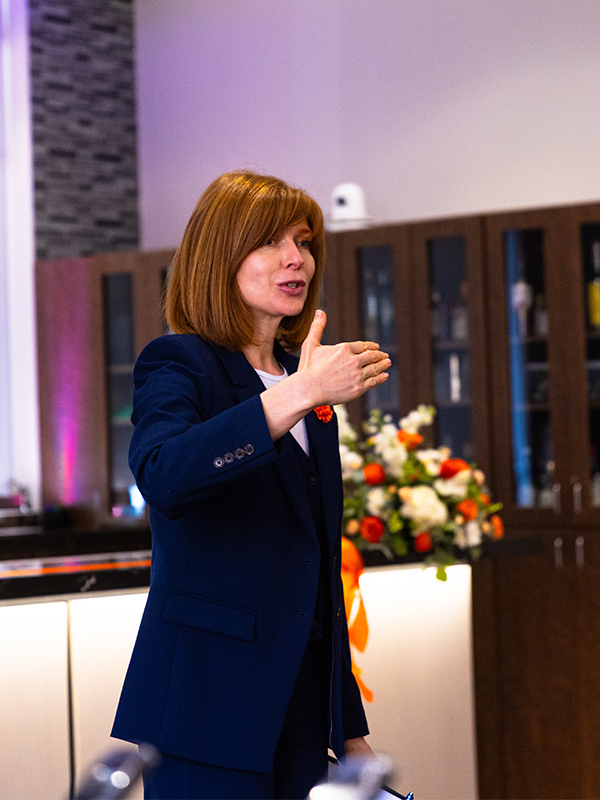 Dr. Lisa Slevitch speaking to a group of people.