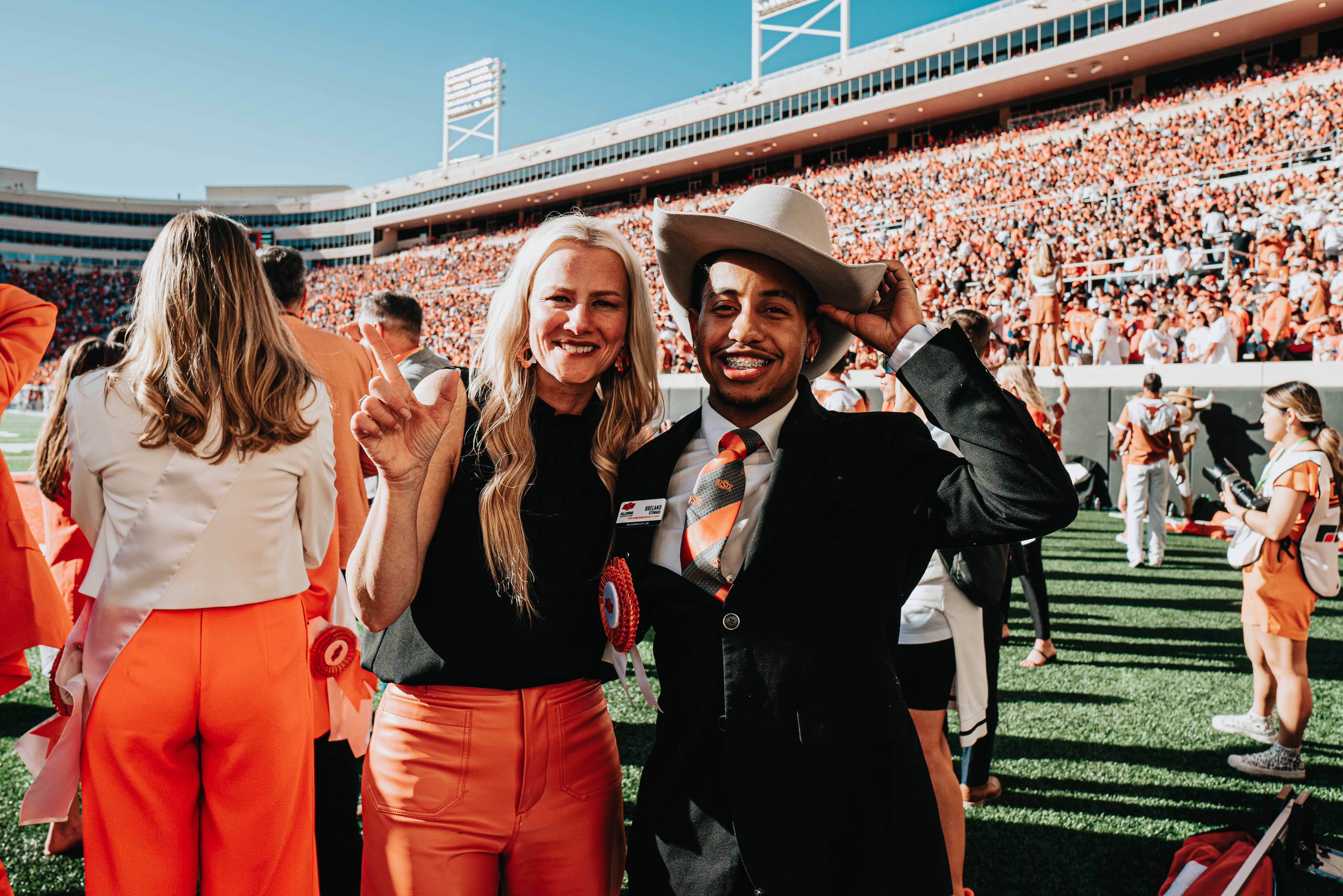 Homecoming King Breland Steward with President Kayse Shrum in Boone Pickens Stadium.