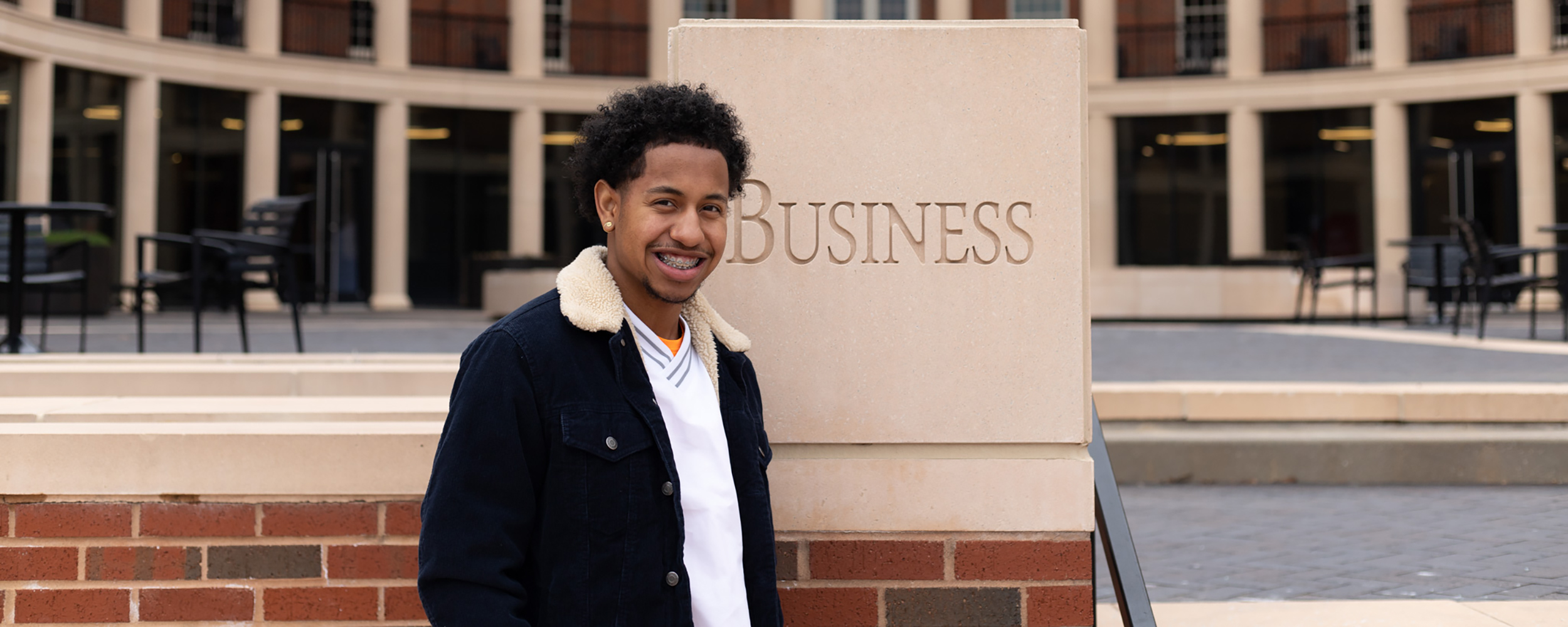 Breland Steward in front of the Spears School of Business.