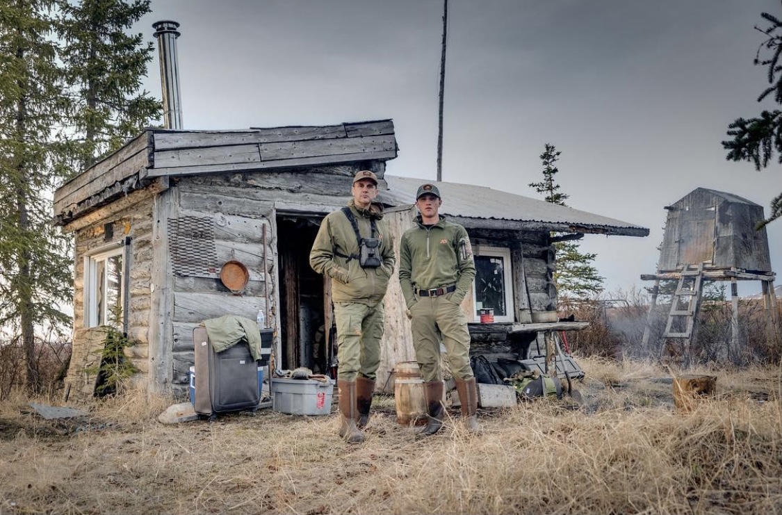 Lincoln and his dad Jim in front of their hunting cabin. 