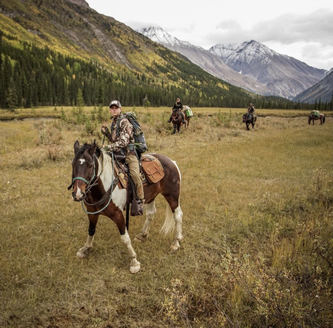 Tapp and his crew riding horseback to their next hunting location.