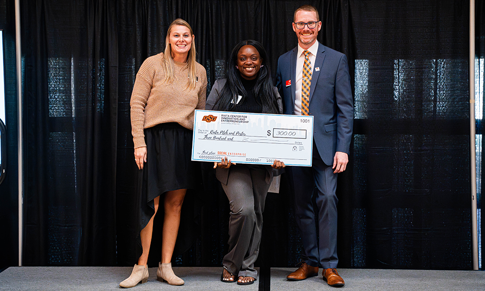 Tianna Etes Tianna Etes accepts a prize check