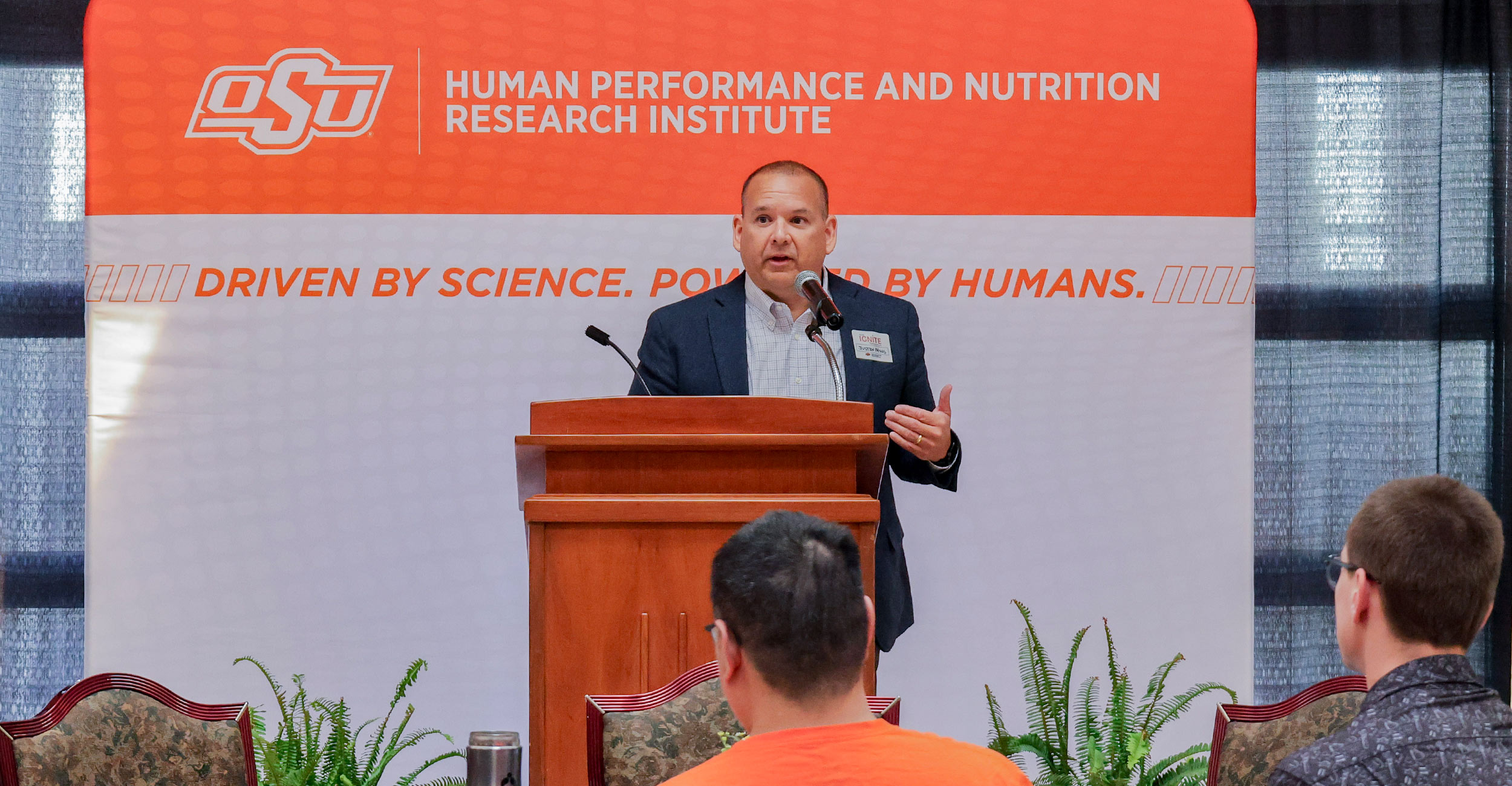 Dr. Justin Quetone Moss stands at a podium and speaks during the ignite symposium