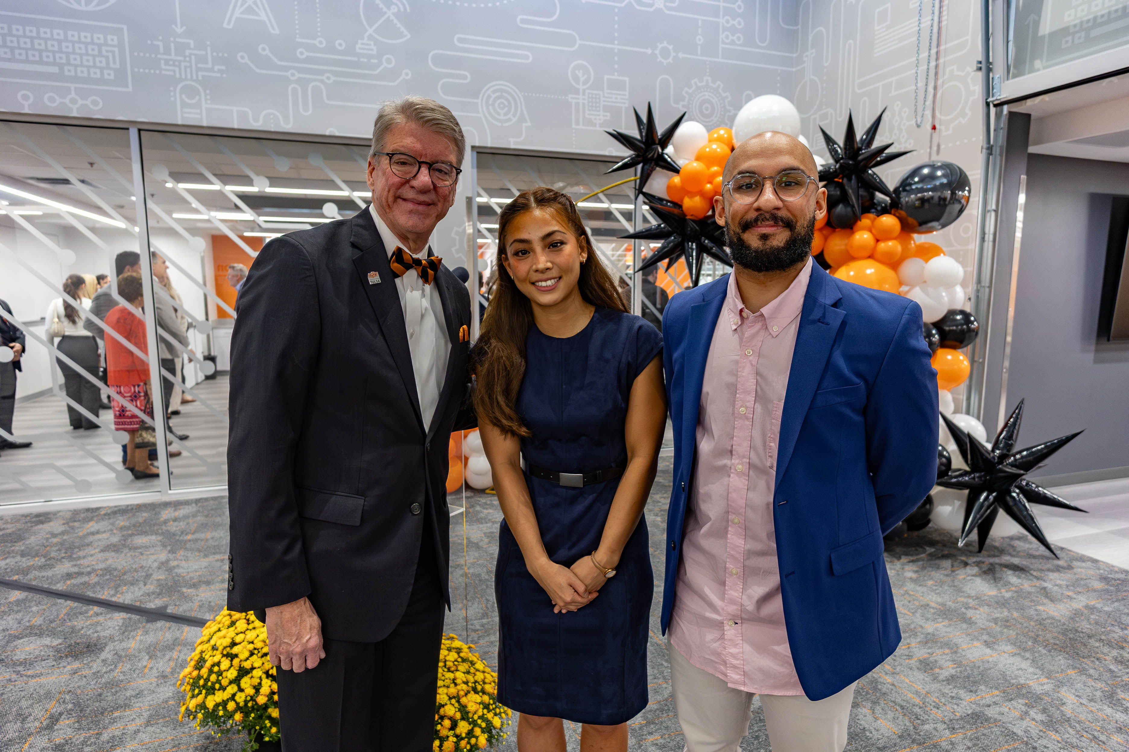 OSU President Hess stands with Jamie Lam, OSU-Tulsa mechanical engineering student and Jonathan Ford, Tulsa Community College student taking classes at OSU-Tulsa through the College Park partnership with TCC.